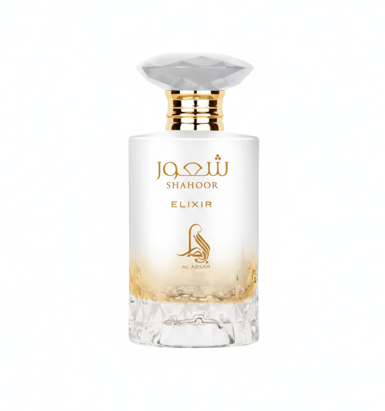 Shahoor Elixir de Lattafa, muestra de perfume en 3 ml y 5 ml. Notas olfativas: salida de limon, caramelo y ron especiado; corazon de leche cremosa y flor de azahar; fondo de vainilla, ambar, benjui y almizcle. Perfume arabe gourmand oriental. Frasco fotografiado sobre fondo blanco. Aroma dulce, calido y envolvente.